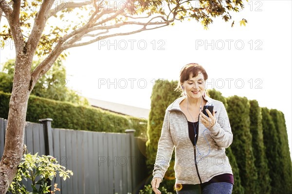 Caucasian woman using cell phone outdoors