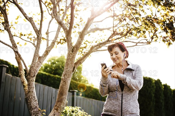 Caucasian woman using cell phone outdoors