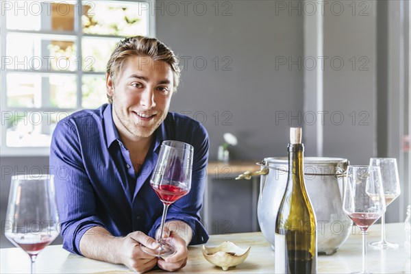 Caucasian man drinking wine in restaurant