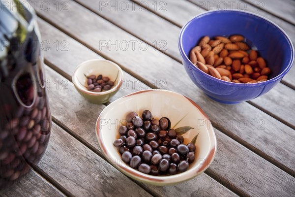 Olives with nuts on table