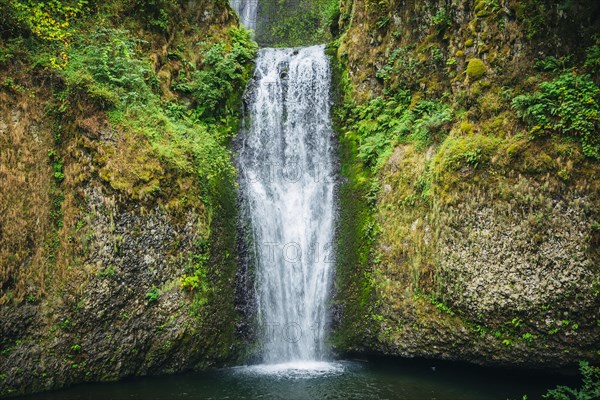 Multnomah Falls over rocky hillside