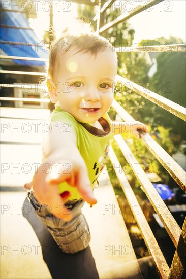 Caucasian boy standing on balcony