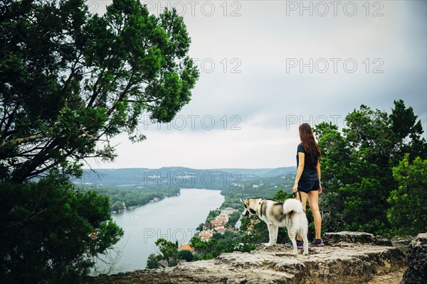 Caucasian woman and dog admiring scenic view