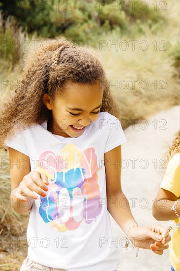 Mixed race sisters walking on dirt path