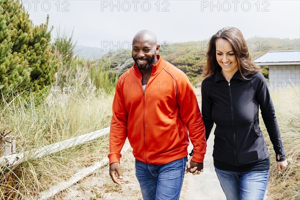 Couple holding hands on beach