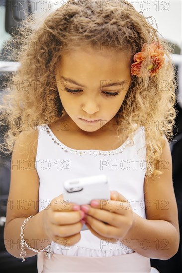 Mixed race girl using cell phone