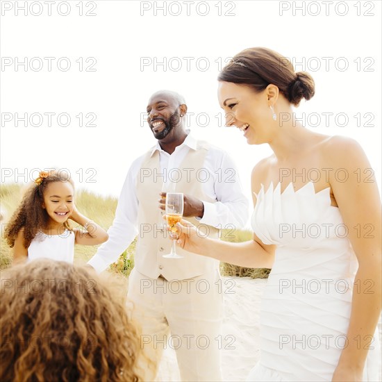 Bride and groom celebrating with flower girl daughters