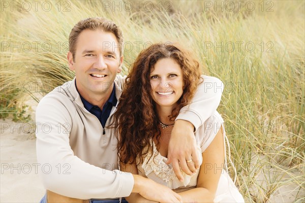 Caucasian couple smiling on beach