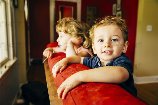 Caucasian children standing on sofa