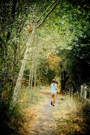 Mixed race girl walking on dirt path