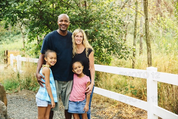 Family smiling on gravel path