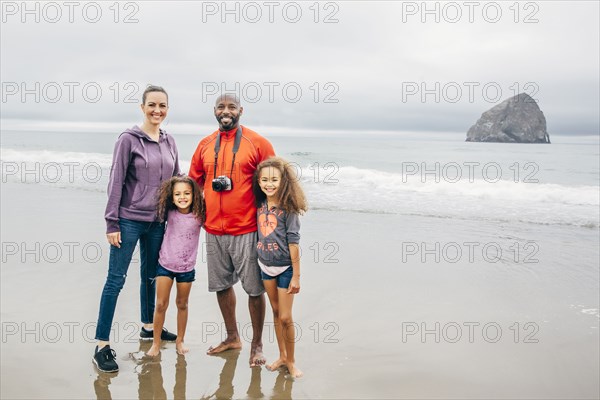 Family smiling on beach
