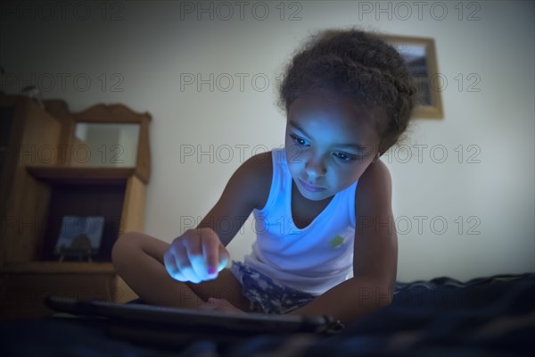 Mixed race girl using digital tablet