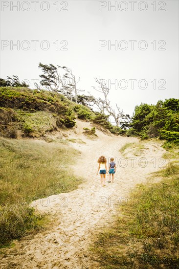 Mixed race sisters walking on beach