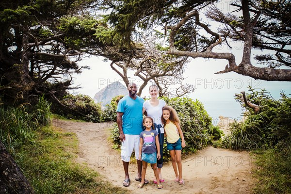 Family smiling on beach path