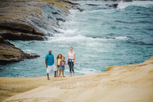 Family smiling on beach