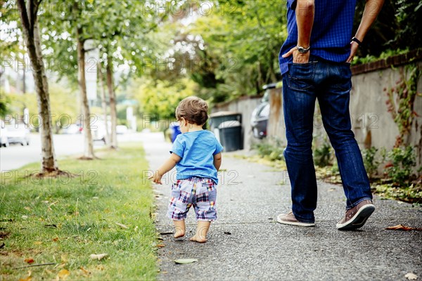 Father and baby son walking outdoors