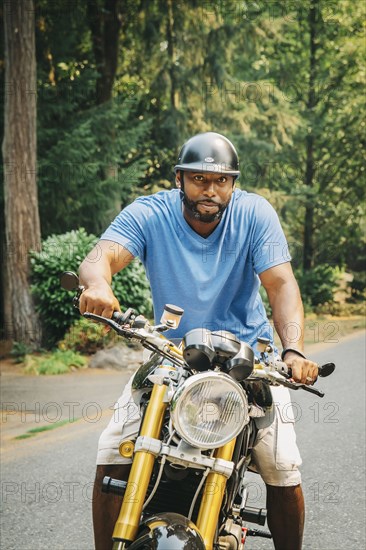 Black man sitting on motorcycle