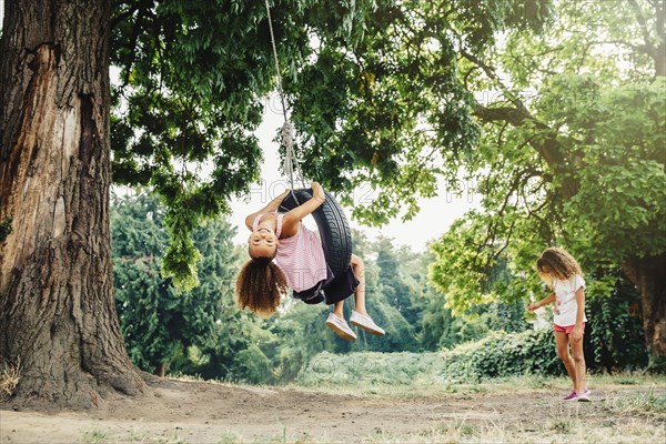 Mixed race sisters playing in backyard