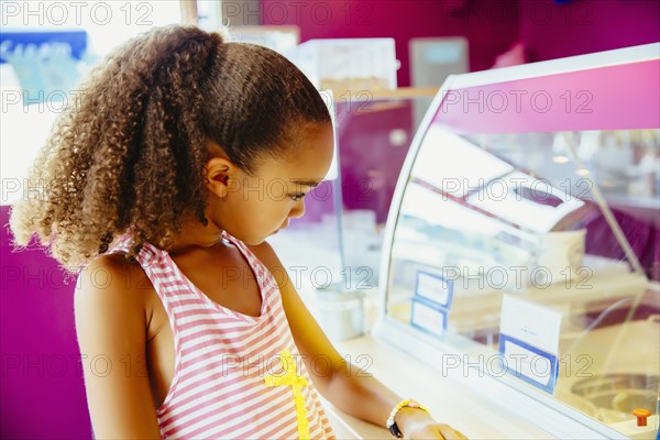 Mixed race girl in ice cream shop