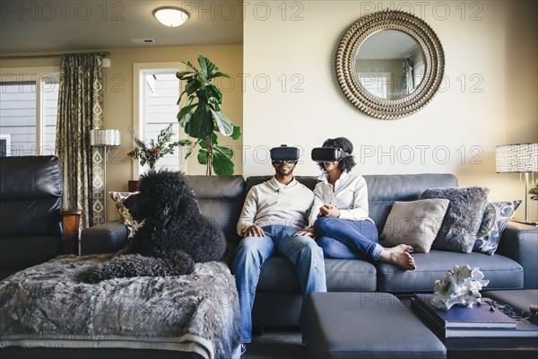 Couple using virtual reality goggles