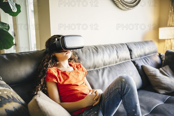 Mixed race girl using virtual reality goggles