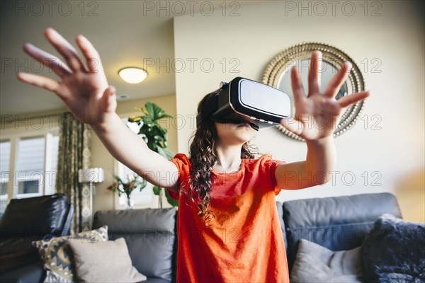 Mixed race girl using virtual reality goggles