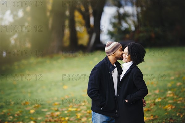 Couple kissing in park