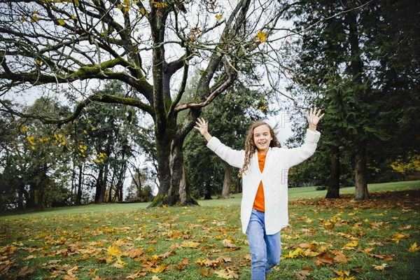 Mixed race girl playing in park