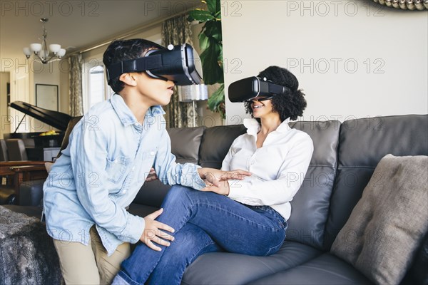 Mother and son using virtual reality goggles