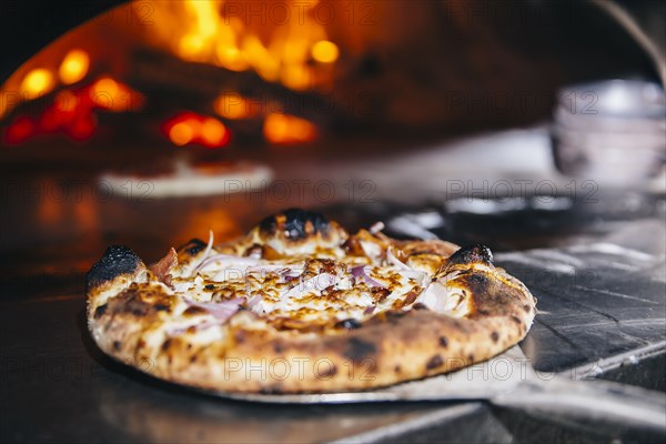 Pizza cooking in wood fired oven