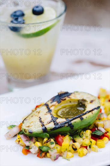 Close up of grilled avocado and salad