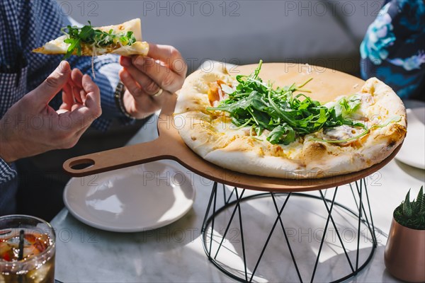 Caucasian couple eating pizza in cafe