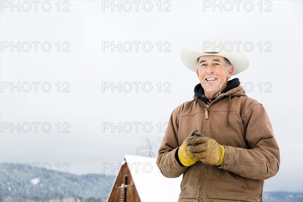 Caucasian farmer smiling in snow