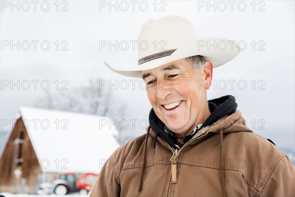 Caucasian farmer smiling in snow