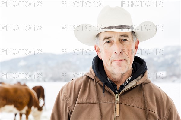 Serious Caucasian farmer in snowy field