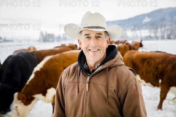 Caucasian farmer smiling in snowy field