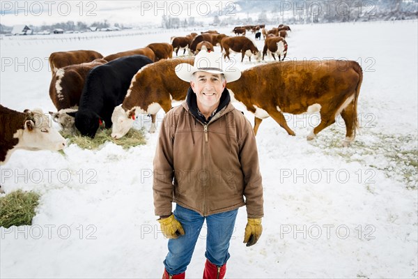 Caucasian farmer smiling in snowy field