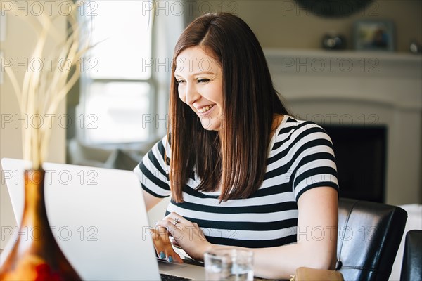 Hispanic woman using laptop