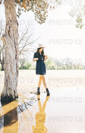 Chinese woman walking near pond