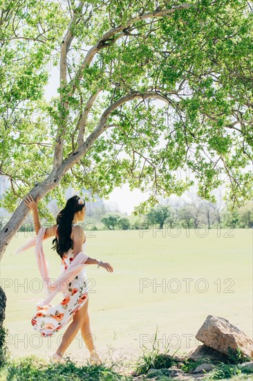 Chinese woman walking near pond