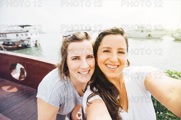 Women taking selfie on Ha Long Bay waterfront