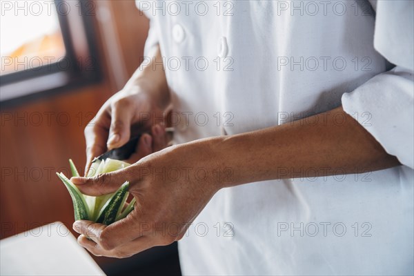 Close up of chef cutting decorative lime