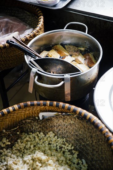 High angle view of pots of soup and rice