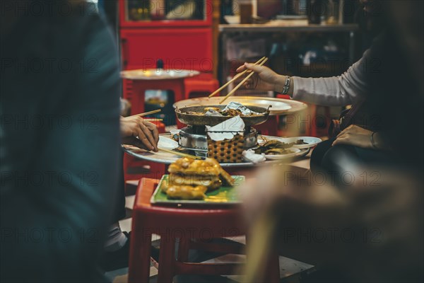 People eating with chopsticks in restaurant