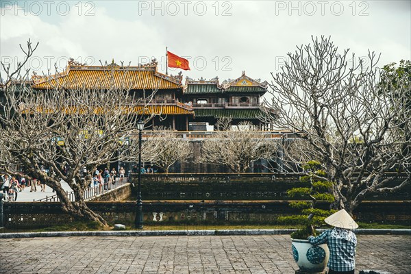 Vendor sitting outside ornate building