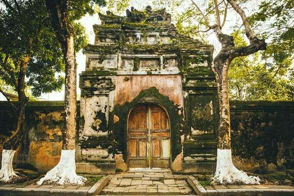 Mossy ornate archway and fence