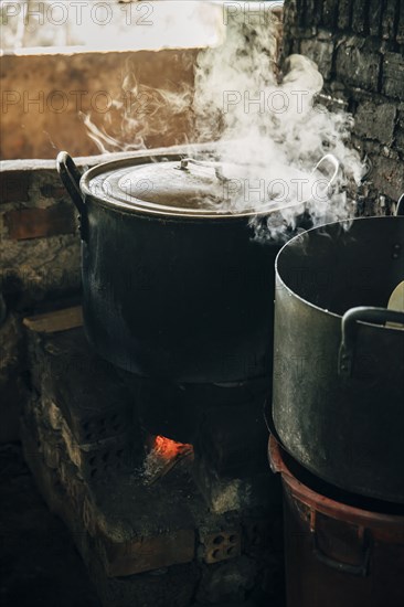 Close up of steamy pot cooking on stove