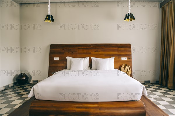 Empty bed in modern hotel room