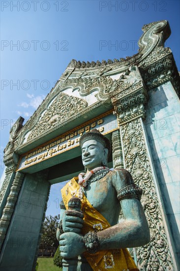 Low angle view of statue and ornate archway at Angkor Wat